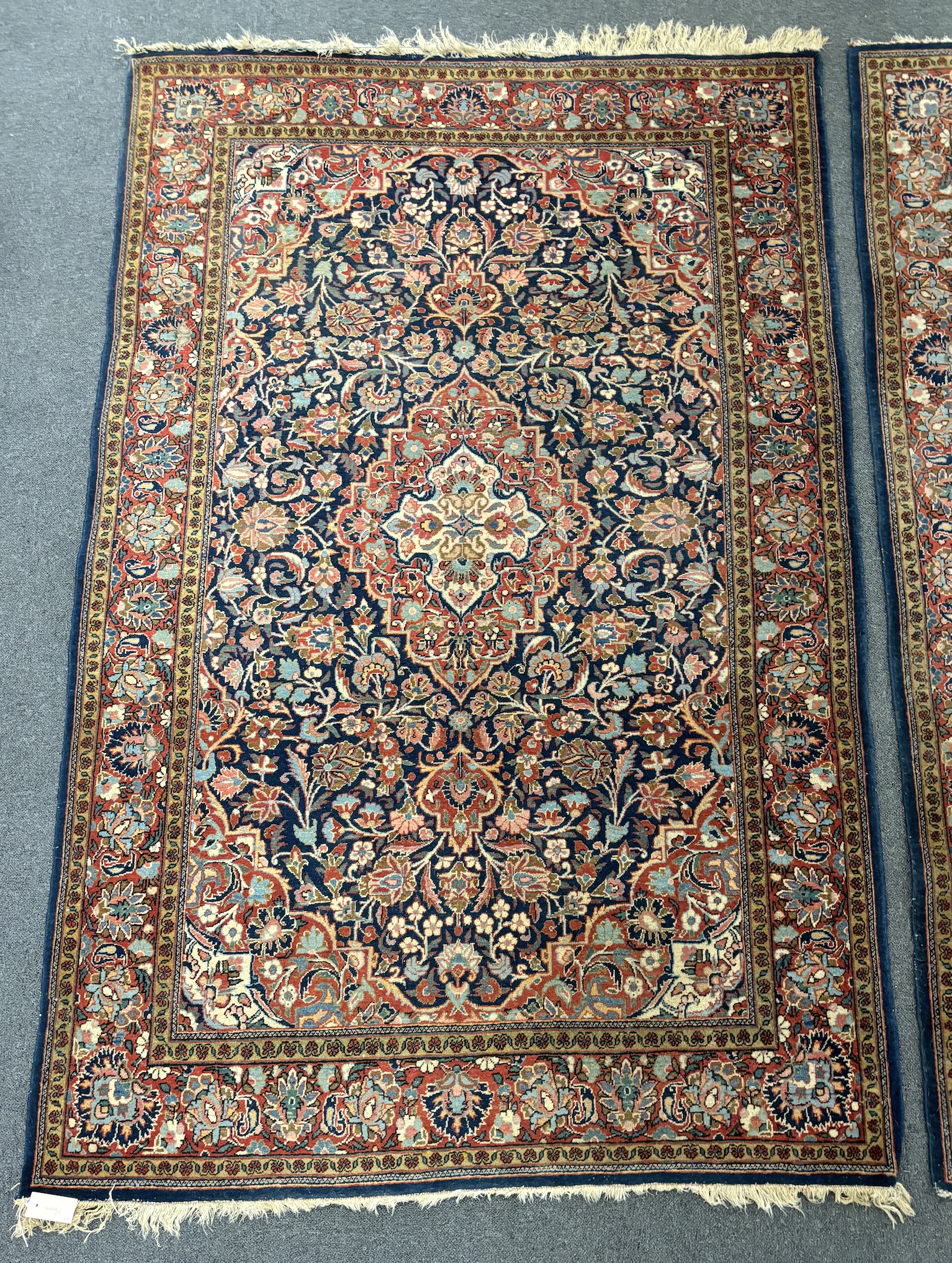 A pair of Kashan blue ground rugs, 216 x 139cm